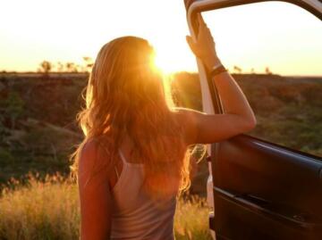 woman holding vehicle door