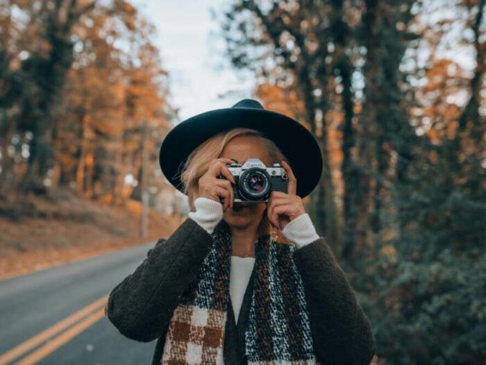 a woman taking a picture of herself with a camera