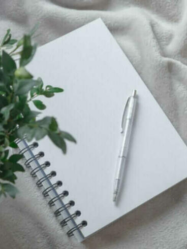 white click pen on white notebook